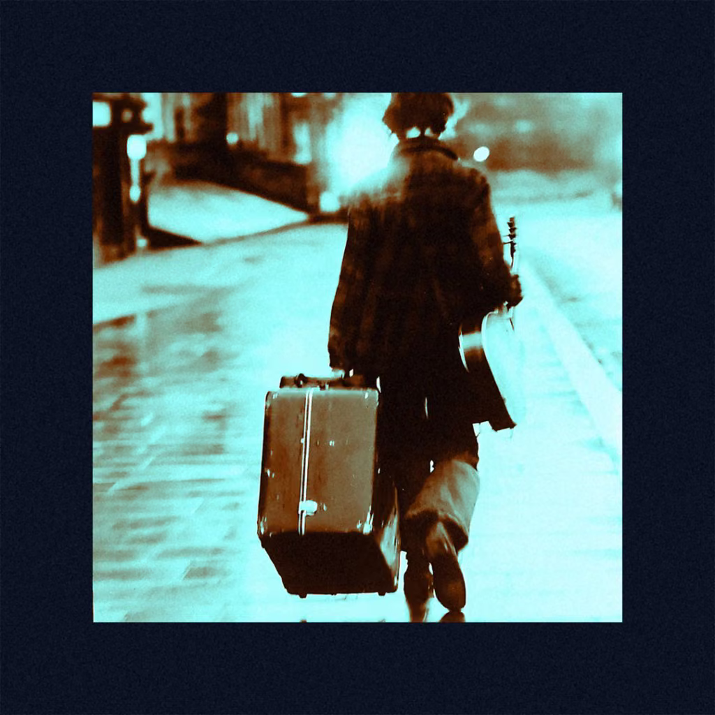 Musician walking away with a suitcase and guitar
